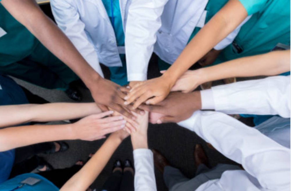 circle with hands joined in the center