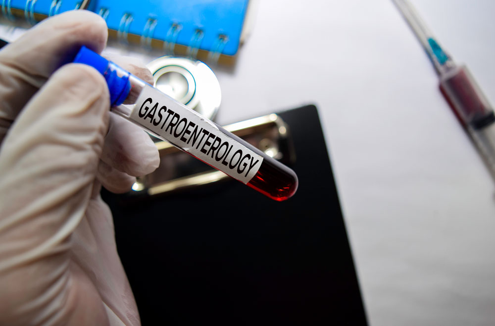 Researcher with vial of blood