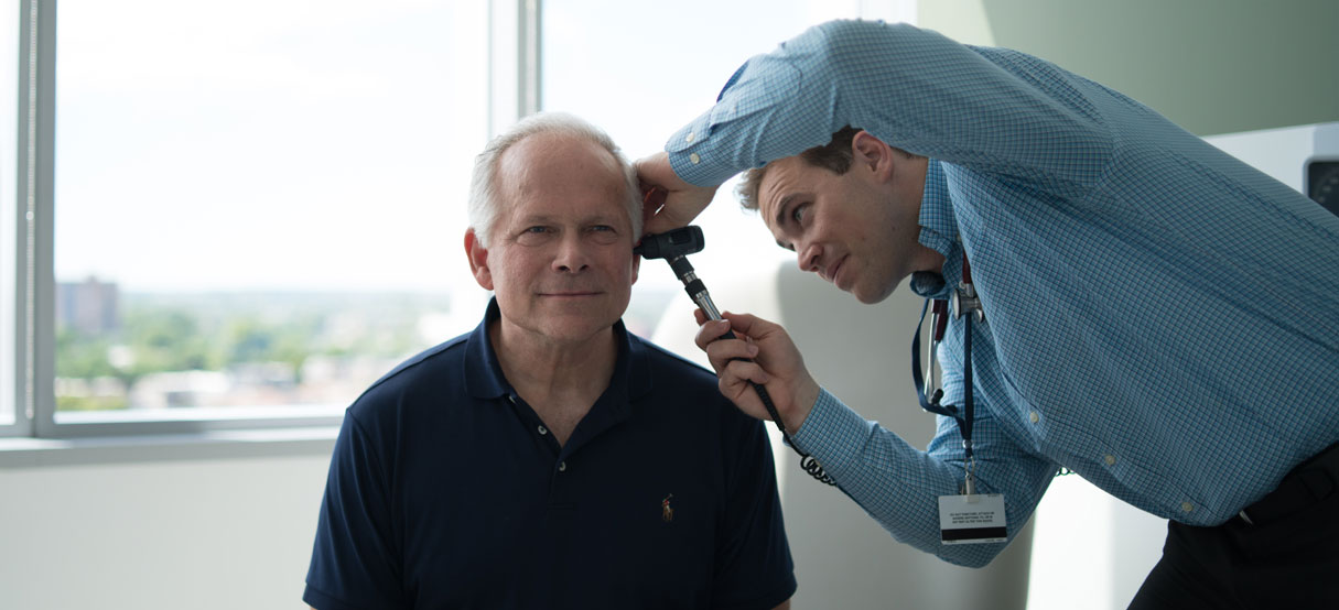 Doctor checking patient's ear