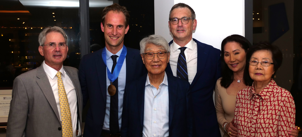 A group shot with Dr. Jan-Karl Burkhardt, Dr. Daniel Yoshor, the Kim Family, and the Dean of the Perelman School of Medicine at a ceremony.