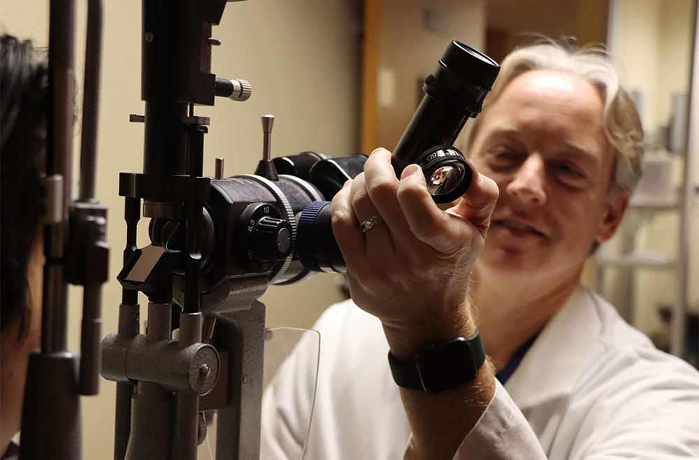 Technician giving eye exam