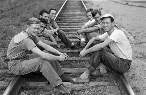 men on railroad tracks