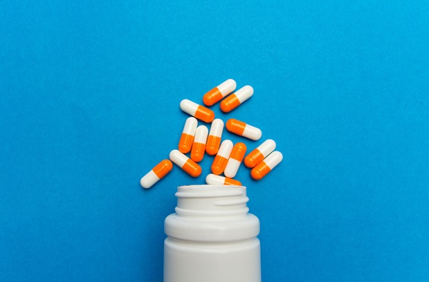 Medicine bottle with pill poured out