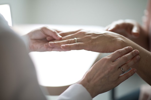 Doctor examining patient hand