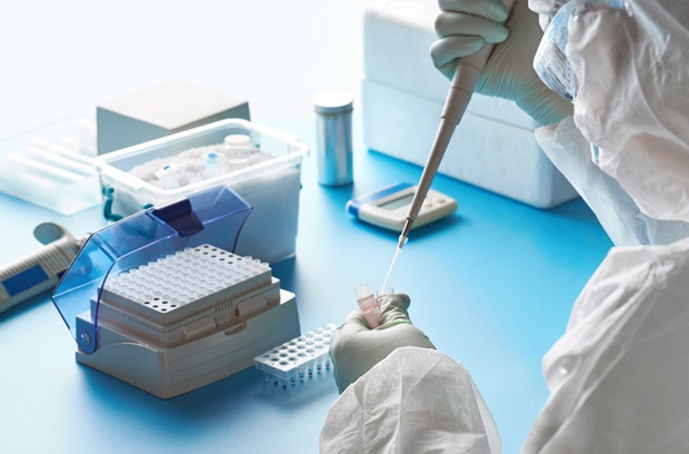 Researcher filling vial for testing