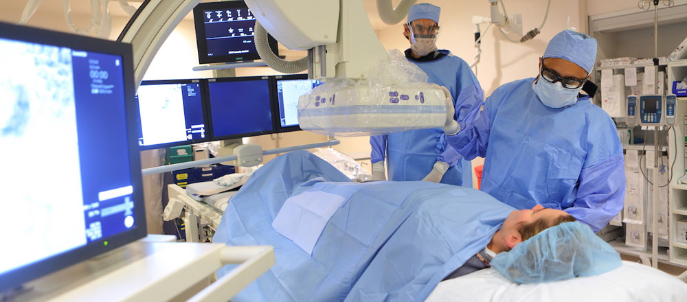 Interventional radiologists with patient