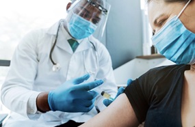 doctor administering vaccine