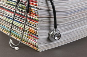stethoscope draped over magazines