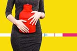 woman with a heating pad on her uterus