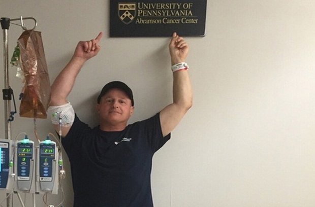 louis spivak cancer survivor points to plaque of penn medicine abramson cancer while hooked to monitors during last days of chemo