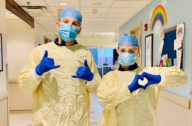 2 nurses posing in front of a wall with a rainbow on it at Pennsylvania Hospital