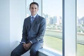 Plastic surgeon Dr. Joshua Fosnot sitting on window ledge