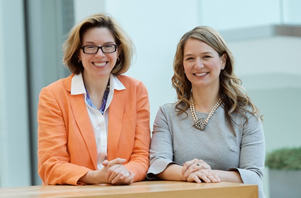 Kathleen O'Neill, MD, MTR and Paige Porrett, MD, PhD smiling at a podium