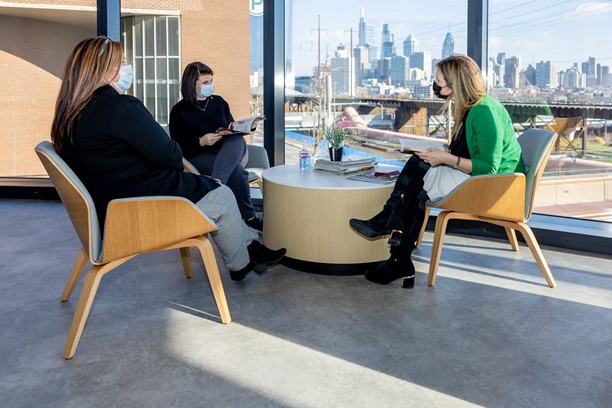 Staff chat in the lounge of the Family Caregiver Center at the Pavilion.