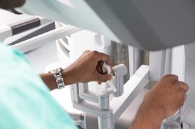 Photo of Dr. Pavan Atluri operating the daVinci surgical robot