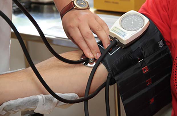 doctor checking patient heart rate