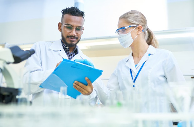 Researchers with clipboard in a lab