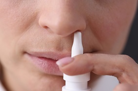Woman using intranasal medication