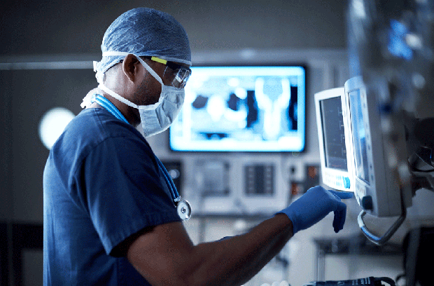 Surgeon looking at monitor in operating room