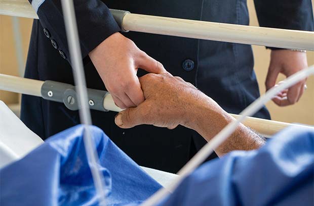 doctor holding patient hand
