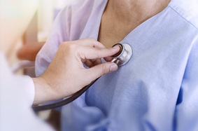  Doctor checking patient's heart with stethoscope at a hospital