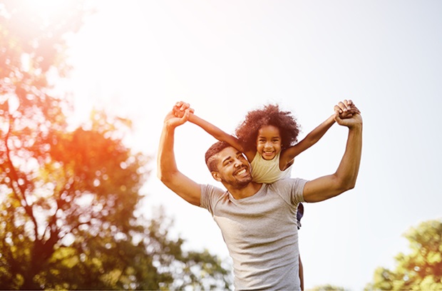 Dad_Lifts_Daughter_Over_Shoulders_Outside_playing