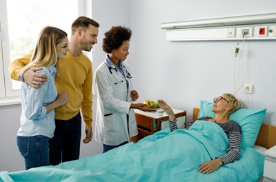 Elderly Patient with Doctor and Family