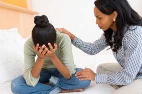 mother consoling her daughter