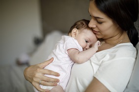 Parent holding baby on their chest