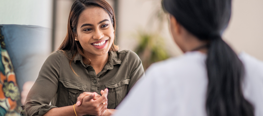 Woman Smiling With Doctor
