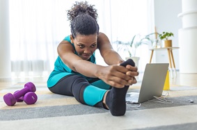 female working out at home pink weights