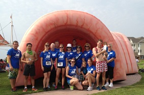 Participants standing in front of an inflatable colon for Get Your Rear In Gear event