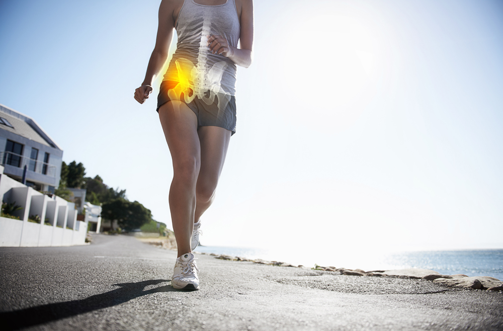 A cropped view of a female jogger on the road experiencing joint inflammation