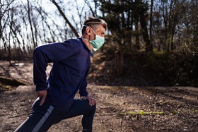 Man in mask stretching