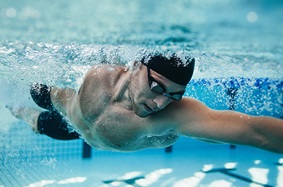 man swimming in pool