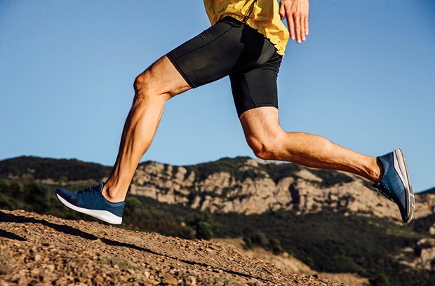 Runner in mid-stride running up a mountain