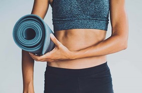 Woman holding a yoga mat