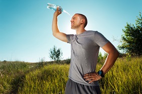Man pouring water on himself 