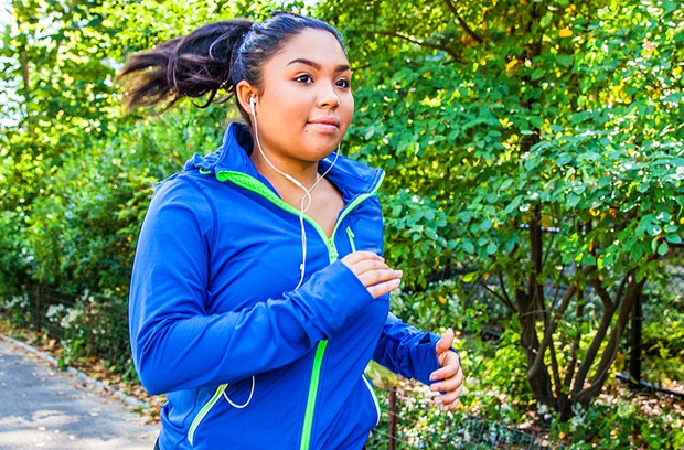 Young woman with ponytail running outdoors in the spring