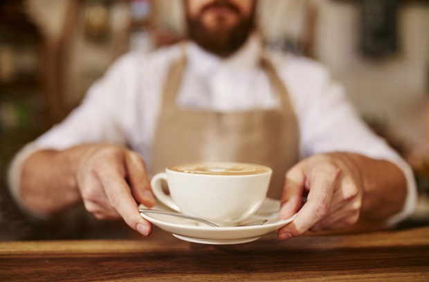 barista serving a cop of coffee