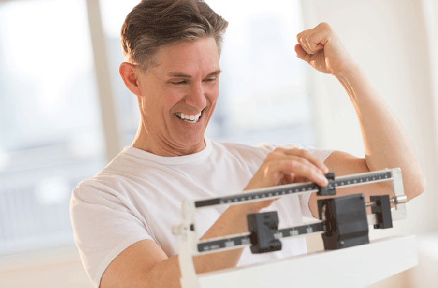 man celebrating on scale