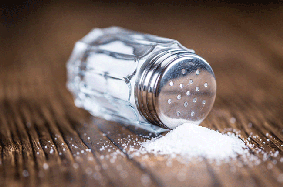 salt shaker on side with salt pouring out of it
