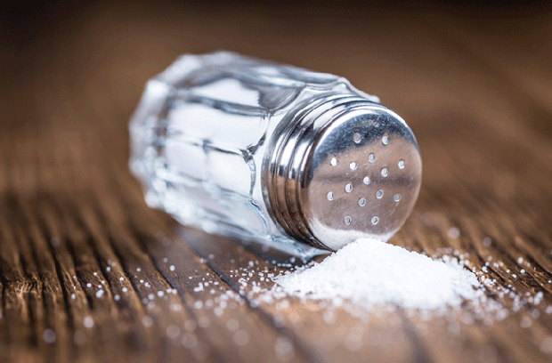 salt shaker on side with salt pouring out of it