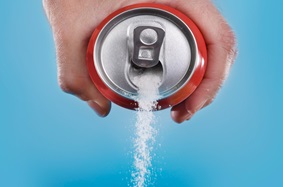 soda can with sugar pouring through it