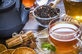 Tea pot with assorted tea and spices on a table
