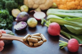 fresh vegetable assortment with vitamins on spoon