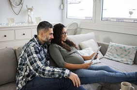 pregnant couple on couch