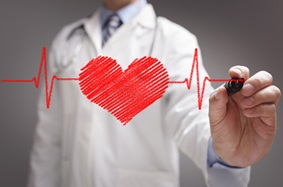 Doctor drawing a heart and heartbeat pattern on glass