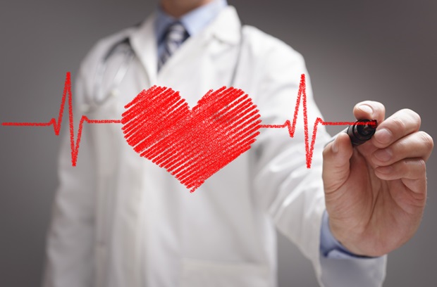 Doctor drawing a heart and heartbeat pattern on glass