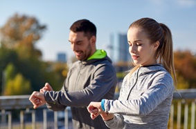a couple looking at their fitness trackers
